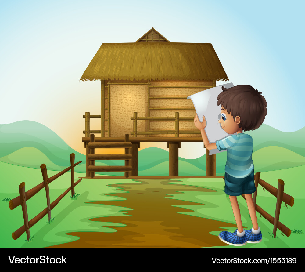 A boy with paper in front of the nipa hut