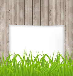 green grass and paper sheet on wooden texture vector