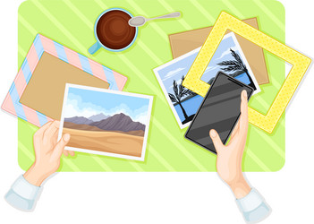 Hands putting postal card in frames at table above vector