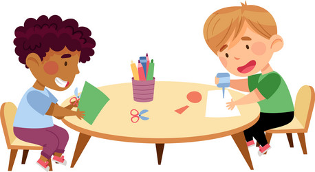 little boys sitting at table paper crafting Vector Image