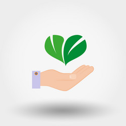 green leaves in the form of heart on hand vector