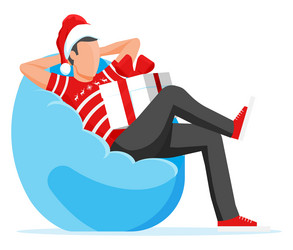 Man sitting in bean bag holding gift box vector