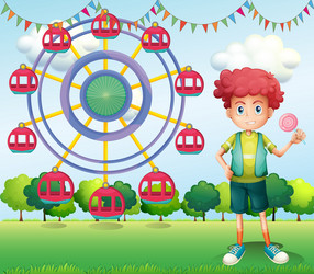 A boy holding lollipop beside ferris wheel vector