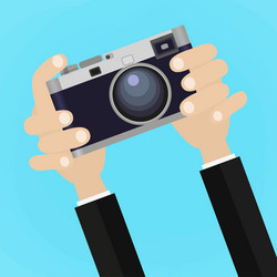 Retro photo camera with hand holding vector