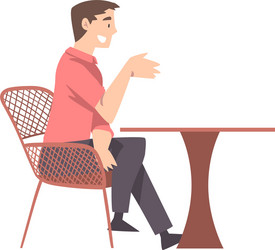 young man sitting at table in cafe drinking vector