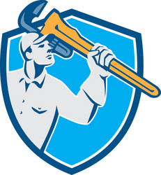 Plumber wielding monkey wrench shield retro vector