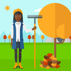 Woman with rake near tree and heap of leaves vector