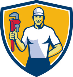 Plumber holding monkey wrench shield retro vector