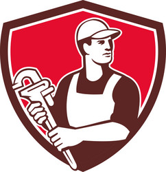 plumber wielding monkey wrench shield retro Vector Image