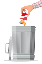 Hand putting cigarettes package in trash bin vector