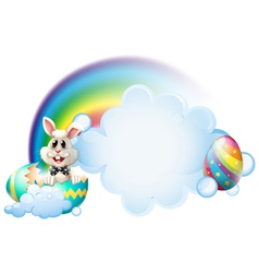 A cracked egg with a bunny near the rainbow vector image