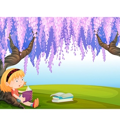 A girl reading a book at the park vector image
