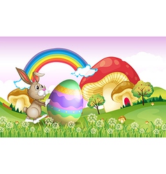 A bunny pushing an easter egg vector image