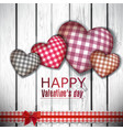 Red cloth handmade hearts on wooden background vector image