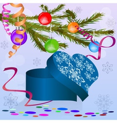 Heart shaped box under Christmas tree branch vector image