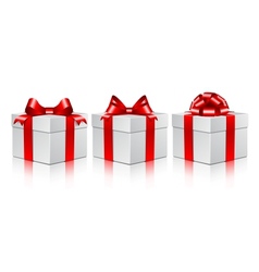 Three white gift boxes with a red bows vector image