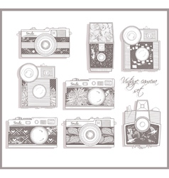 Retro photo cameras set with floral pattern vector image