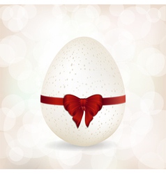 White speckled egg and red ribbon background vector image