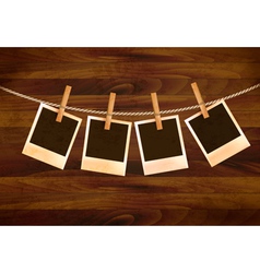 Retro photos hanging on a rope on dark wooden vector image