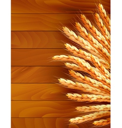 Ears of wheat on wooden background vector image