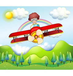 A boy riding in a red plane vector image