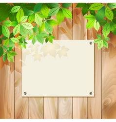Green leaves on a wood texture background vector image