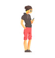 Guy with smartphone in short-sleeve hoodie young vector image