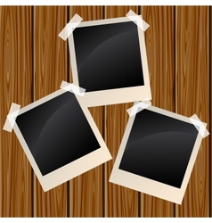 Blank photos on a wooden wall vector image