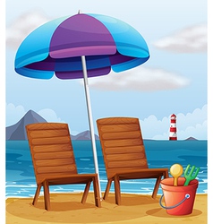 A beach with an umbrella and chairs vector image