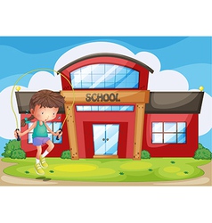 A girl playing in front of the school vector image