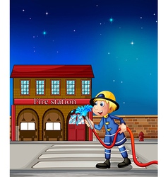 A fireman near a fire station vector image