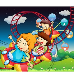 Three kids riding in a roller coaster vector image
